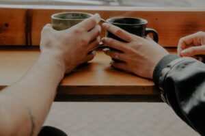 Two hands holding coffee cups